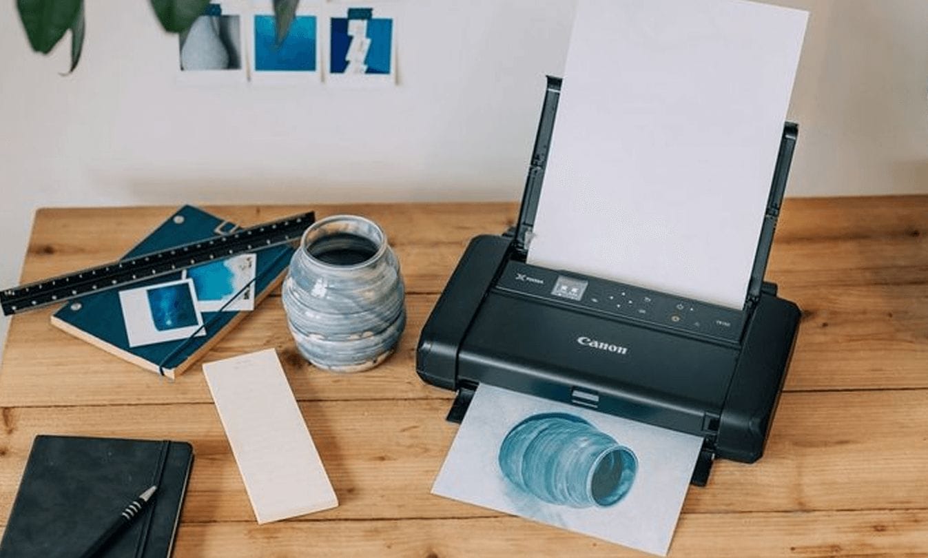 Canon PIXMA TS3460 wireless printer printing a design onto paper.