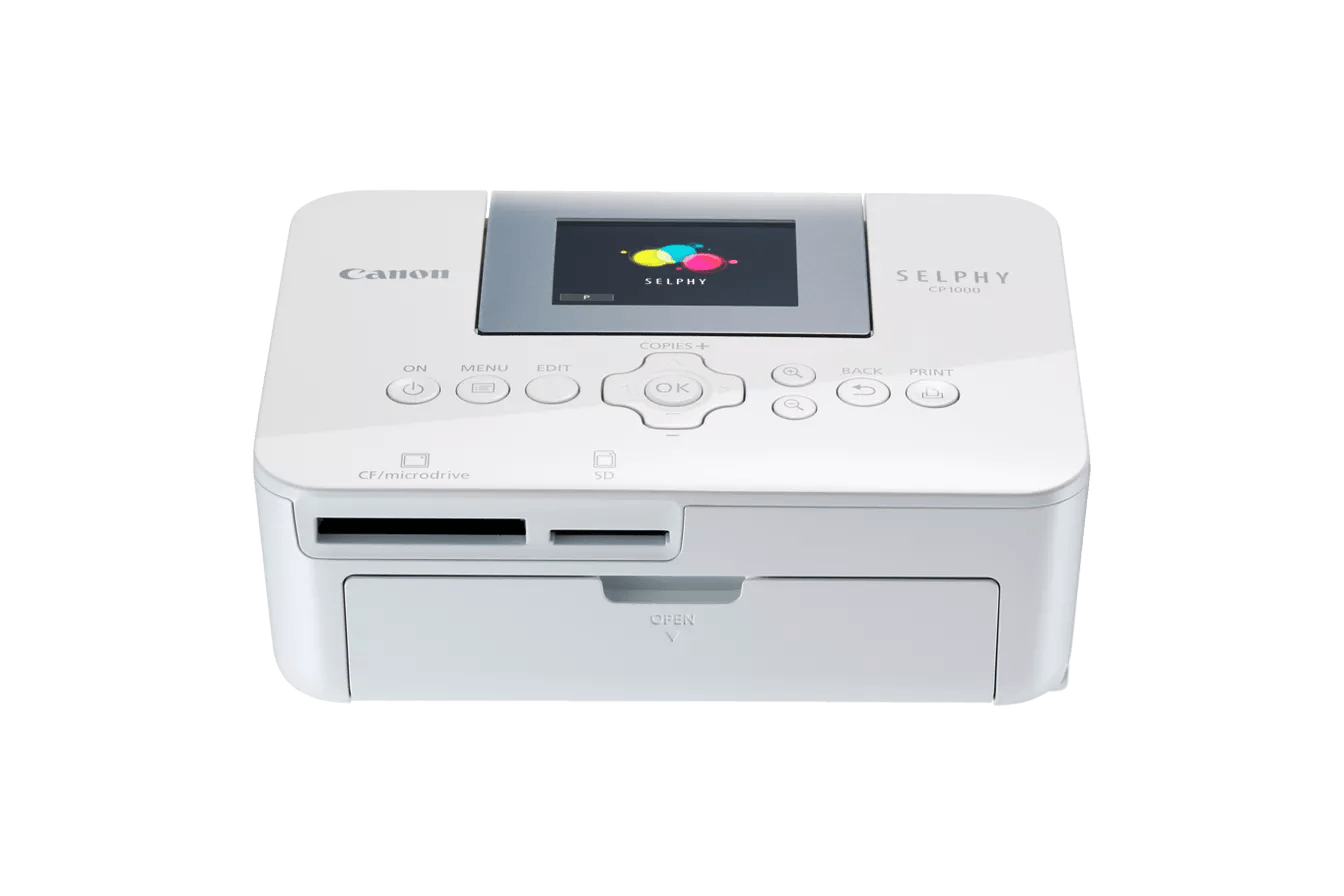 Canon SELPHY CP1000 portable photo printer. Compact design with LCD screen and card slots.