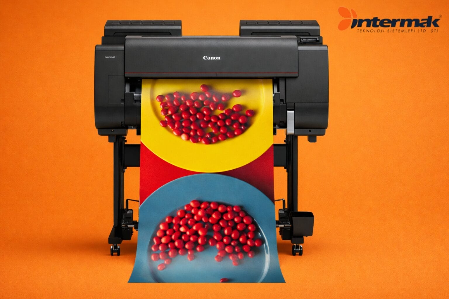 Canon fotoğraf baskı makinesi, üzerinde kırmızı şekerlemeli tabakların baskısı.